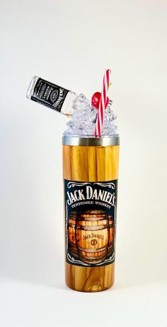 a jack daniels drink in a can with a candy cane sticking out of it