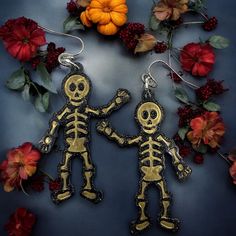 Brown & Gold Glitter Resin Skeleton Halloween Earrings *Nickel Free post *Skeletons measure approximately 2" *Lightweight *Rubber stoppers included Each of my pieces is handcrafted with love and attention to detail. I appreciate your business and thank you for visiting my shop Find Blue Diva Creations Online at: Web: www.bluedivacreations.com Facebook: www.facebook.com/BlueDivaCreations Instagram:  bluedivacreations Skeleton Beaded Earrings, Gold Dangle Halloween Jewelry, Gold Novelty Earrings For Halloween, Fish Skeleton Earrings, Halloween Skull Print Earrings, Steve Madden Sunglasses, Novelty Black Halloween Earrings, Black Trucker Hat, Leather Driving Gloves