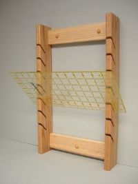 a wooden frame with some yellow tape on it and a white wall in the background