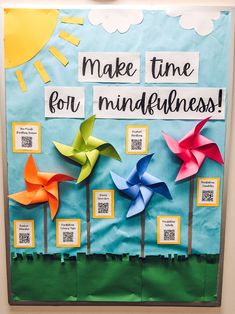 a bulletin board with four pinwheels and the words make time for mindfulness