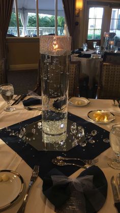 the table is set up with silverware and place settings for two people to eat