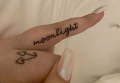 a person's hand with a tattoo that reads moonlight