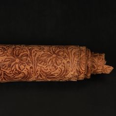 an intricately carved piece of wood on a black background