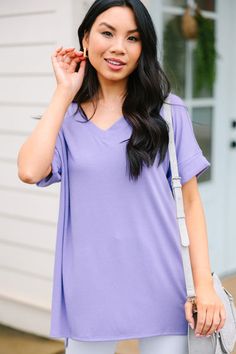 This versatile v-neck tee is here to make your life easy! It's honestly the perfect top for year round styling and layering. You can knot the hem or half tuck into your favorite jeans or shorts. You can layer it with all sorts of jackets, shackets, or kimonos. And don't even get us started on accessories! The options are absolutely endless! This top is truly a staple piece! This top features a v neckline, short cuffed sleeves, and a generous fit. Material has generous amount of stretch.Cindy is Casual Solid Color V-neck Top For Spring, Casual V-neck Top For Spring, Spring Cotton V-neck Top For Loungewear, Cotton V-neck Top For Spring Loungewear, Trendy Lavender T-shirt For Summer, Lavender Trendy T-shirt For Summer, Lavender Tops For Spring Layering, Trendy Lavender Summer T-shirt, Spring V-neck T-shirt For Loungewear