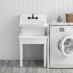 a washer and dryer sitting next to each other in front of a white wall