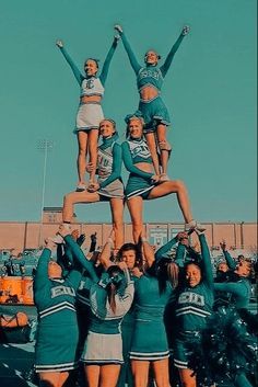 a group of cheerleaders standing on top of each other