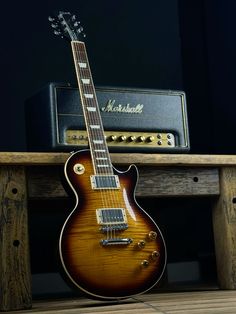 an electric guitar sitting on top of a wooden table