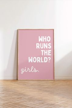 a pink poster with the words who runs the world? on it in white lettering