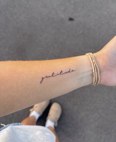 a woman's arm with a tattoo that reads, just breathe on it and the word