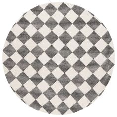 a round rug with black and white checkered pattern on the bottom, in front of a