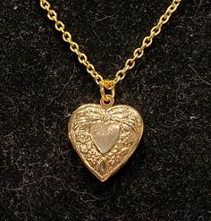 Necklace is gold in color Measures 18 inches in length Locket measures 1 inch in length and width Cheap Heart Shaped Locket Jewelry, Luxury Heart Shaped Locket Necklace, Cheap Heart-shaped Locket Jewelry, Luxury Romantic Locket Necklace, Luxury Gold Heart Pendant Locket Necklace, Luxury Elegant Heart Pendant Locket Necklace, Luxury Rose Gold Locket Necklace, Luxury Gold Locket Necklace With Heart Charm, Cottagecore Locket Necklace