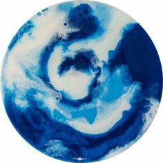 a blue and white plate with swirl designs on it