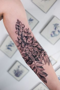 a black and white flower tattoo on the arm