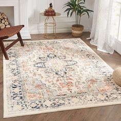 a large rug with an ornate design on the floor in a living room next to a chair