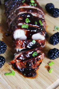 the meat is covered with blackberries and has sauce on it for garnishes