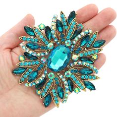 Gorgeous large rhinestone brooch with teal blue, aqua and iridescent crystals, which can be used for your DIY project - wedding, cake and pillow decorations, dress and costume accessory, event decor, crafts, scrap booking and much more! Size: 4 inch high 3 1/4 inches wide Metal: dark gold plated This extra large crystal brooch can be ordered with pin in the back to add to your gown or dress sash, to wire into brooch bouquet, or any number of other craft projects; or without the pin as a flat bac Navy Wedding Bouquet, Blue Brooch, Brooch Dress, Iridescent Crystal, Full Throttle, Dress Sash, Brooch Bouquet, Large Crystal, Animal Coloring