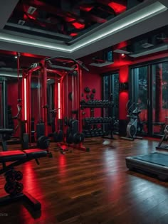 a gym with red lighting and equipment