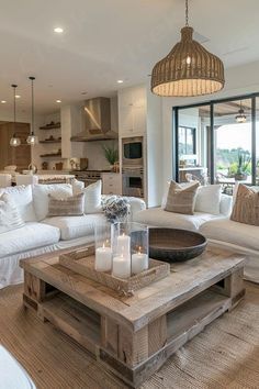 a living room filled with white furniture and lots of pillows on top of it's couches