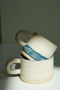 three ceramic cups stacked on top of each other