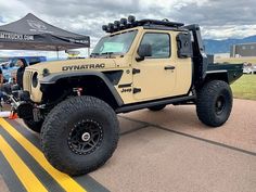 a jeep is parked on the side of the road with people standing around looking at it