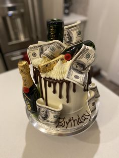 a birthday cake decorated with money and wine