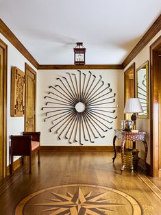 a room with wood floors and wall decorations