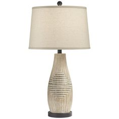 a table lamp with a beige shade on it