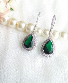 Long and shiny classical earrings made with cubic zircon micro inlay,  emerald green crystal and faux pearls around the rim.  They are One Of A Kind Perfect for a bride, bridesmaid or any special occasion to add some diamond glamour.The pictures are taken without any additional lights - only sunshine. Size: 1.7x4cm - 0.5x1.6" If you need more of them or have any special requests, please feel free to contact me :)Please visit my shop for more earrings https://www.etsy.com/uk/shop/MeAndEmily?ref=h Green Pearl Drop Wedding Jewelry, Green Pearl Drop Jewelry For Wedding, Elegant Emerald Bridal Earrings For Anniversary, Green Bridal Earrings With Elegant Design, Green Elegant Wedding Earrings, Green Teardrop Crystal Earrings, Green Crystal Teardrop Earrings, Elegant Green Emerald Earrings, Elegant Emerald Bridal Earrings