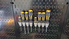 there are many screwdrivers that are on the wall in front of each other