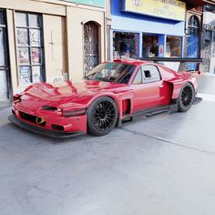 a red sports car parked in front of a building