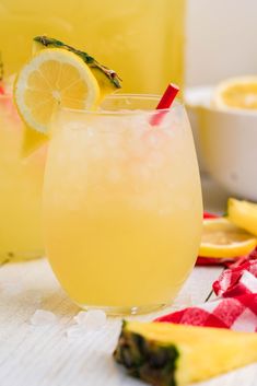 two glasses filled with lemonade sitting on top of a table