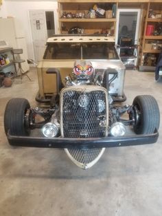 an old model car is parked in a garage