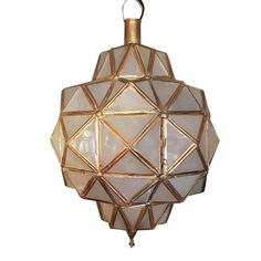 a hanging light made out of glass and gold colored metal with geometric shapes on the sides