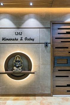 the entrance to an office building with a clock on it's wall and illuminated sign