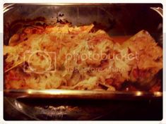 a casserole dish with meat and cheese in a metal pan on the stove