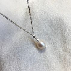 A stunning single, cultured Akoya pearl pendant necklace, on a sterling silver chain. * 6.5mm cultured Akoya pearl  * 2mm crystal (don't like the crystal? Message me)  * 16" / 40cm sterling silver rope chain * boltring clasp * classic minimalist design  A truly beautiful ivory white Japanese Akoya pearl with neutral creams in its fabulous natural lustre. The tiny genuine crystal adds a touch of sparkle. Running freely on a simple sterling silver chain, this pearl pendant necklace is perfect for Classic White Pear Solitaire Necklace, Pearl Necklace With Round Pearl Charm Pendant, Classic Silver Necklace With Pearl Pendant, Classic Round Pearl Necklace With Delicate Chain, Classic Pear-shaped Silver Solitaire Necklace, Akoya Pearl Necklace With Round Pendant As A Gift, Pearl Necklace With Round Pearl Pendant, Classic White Gold Pearl Necklace In Pear Shape, Anniversary Pearl Necklace With Round Pendant