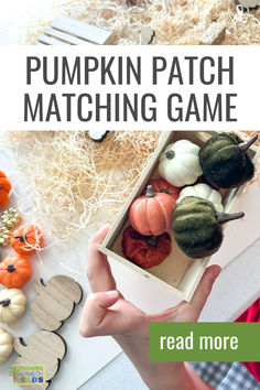 A child’s hand holding a wooden box filled with mini faux pumpkins of different textures and colors as part of a Pumpkin Patch Matching Game. The background features natural wood excelsior, wooden pumpkin cutouts, and more faux pumpkins scattered across the surface. Text overlay reads 'Pumpkin Patch Matching Game,' with a 'read more' button at the bottom right. The Growing Hands-On Kids logo appears in the lower left corner. Play Activity, Fall Activity, Memory Game, Mini Pumpkins, Memory Games, Autumn Activities, Play Activities, Different Textures