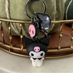 a keychain with a pig on it sitting in front of a pile of towels