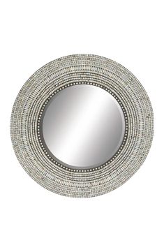 a round mirror with beading around it