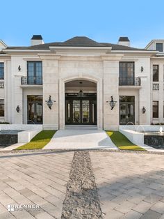 the front entrance to a large white mansion