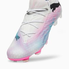 a pair of white and pink soccer shoes