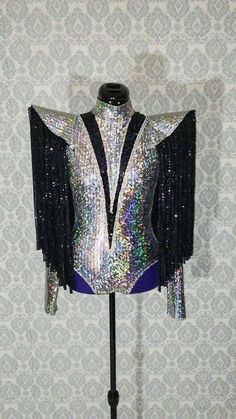 a silver and black jacket with sequins on it