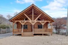 a log cabin with porch and covered patio