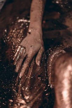 a person's hand covered in gold glitter