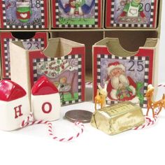 several boxes with christmas decorations on them sitting next to some candy canes and other items