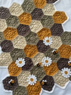 a crocheted hexagon with white flowers on it