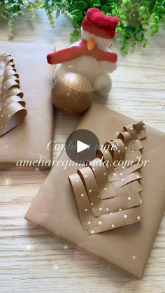 a video demonstrating how to make paper snowmen and christmas tree decorations for the holiday season