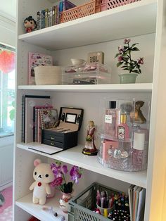 a white book shelf filled with lots of items