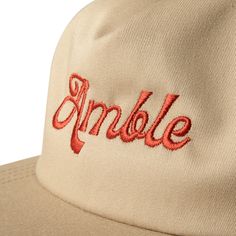 The Retro Script Snapback -This hat is a salute to the era of bold statements and carefree vibes, designed for the man who appreciates a classic throwback intertwined with modern comfort. Featuring a casual five-panel, unstructured design, this hat captures the essence of a decade known for its laid-back approach to fashion Khaki - 5 panel unstructed hat Classic Flat Brim Dad Hat For Streetwear, Classic Trucker Hat With Short Brim, Retro Snapback Hat With Short Brim For Streetwear, Retro Short Brim Snapback Hat For Streetwear, Classic 5-panel Hats For Streetwear, Classic Short Brim Baseball Cap For Streetwear, Classic 5-panel Trucker Hat For Streetwear, Bold Statements, Khaki Color