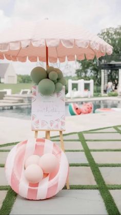 an inflatable pool float with balloons on it and a sign that says welcome